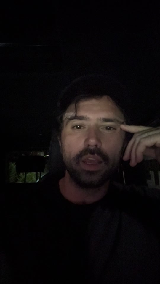 Eduard speaking in low light, with a finger resting near his temple.