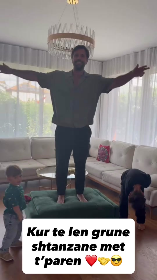 Eduard standing on a green ottoman with arms outstretched while family members are nearby, in the original video thumbnail.
