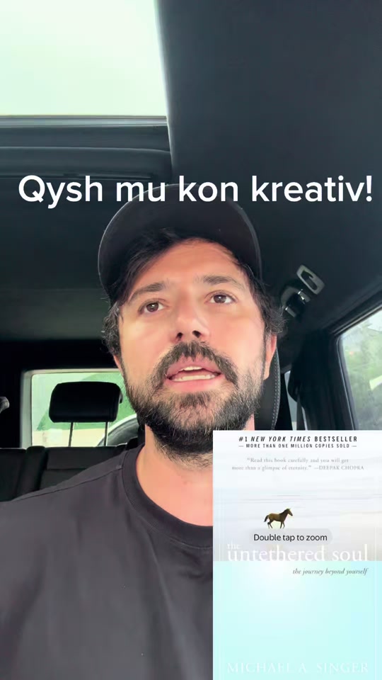 Eduard in a car wearing a dark cap, with The Untethered Soul book cover overlaid beside him.