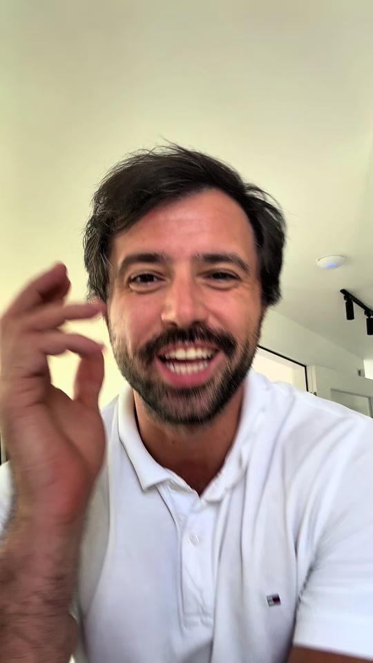 Eduard Luta gesturing in a white polo while discussing flight subsidies indoors.