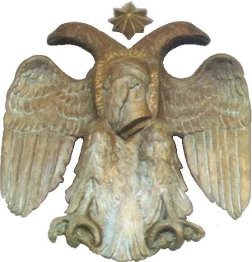 Double-headed eagle with star/sun-like symbol