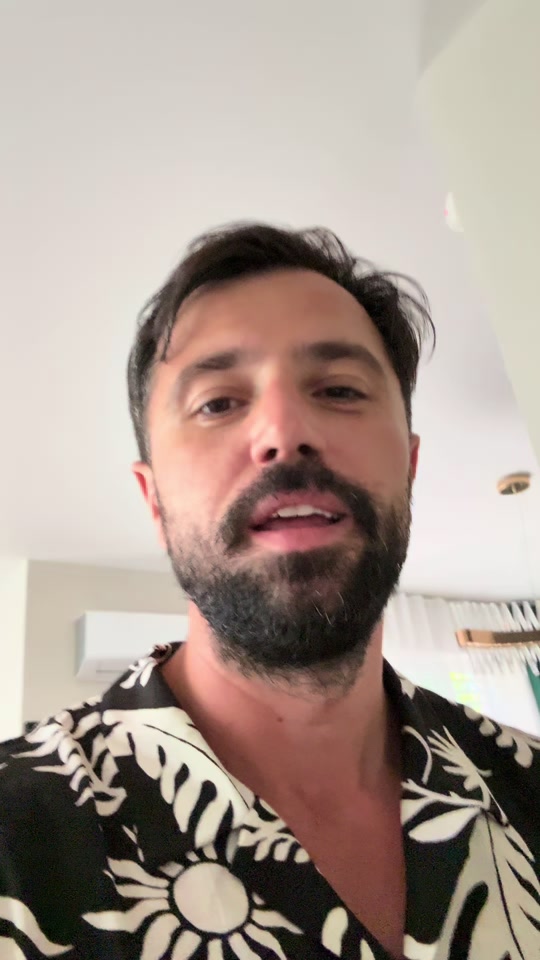 Eduard indoors in a black and white patterned shirt in the original video about Yogananda and beauty.